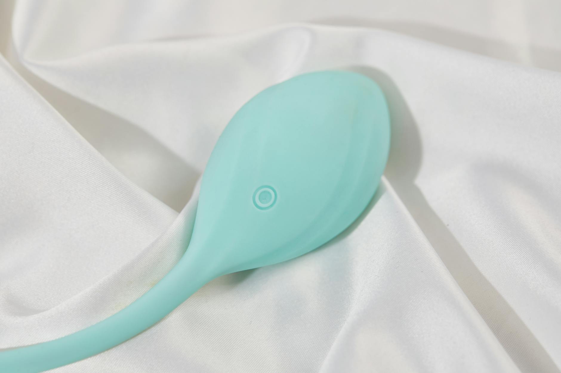 A blue silicone vibrator held gently in hand, symbolizing self-care and pleasure during stressful periods