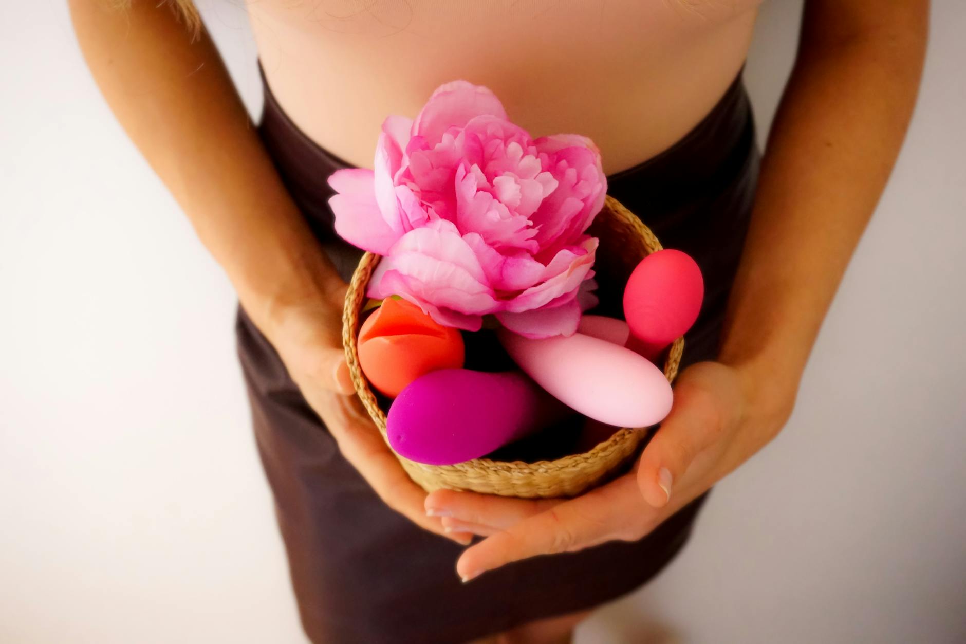 Teal silicone vibrator on smooth silk fabric, symbolizing elegant adult wellness