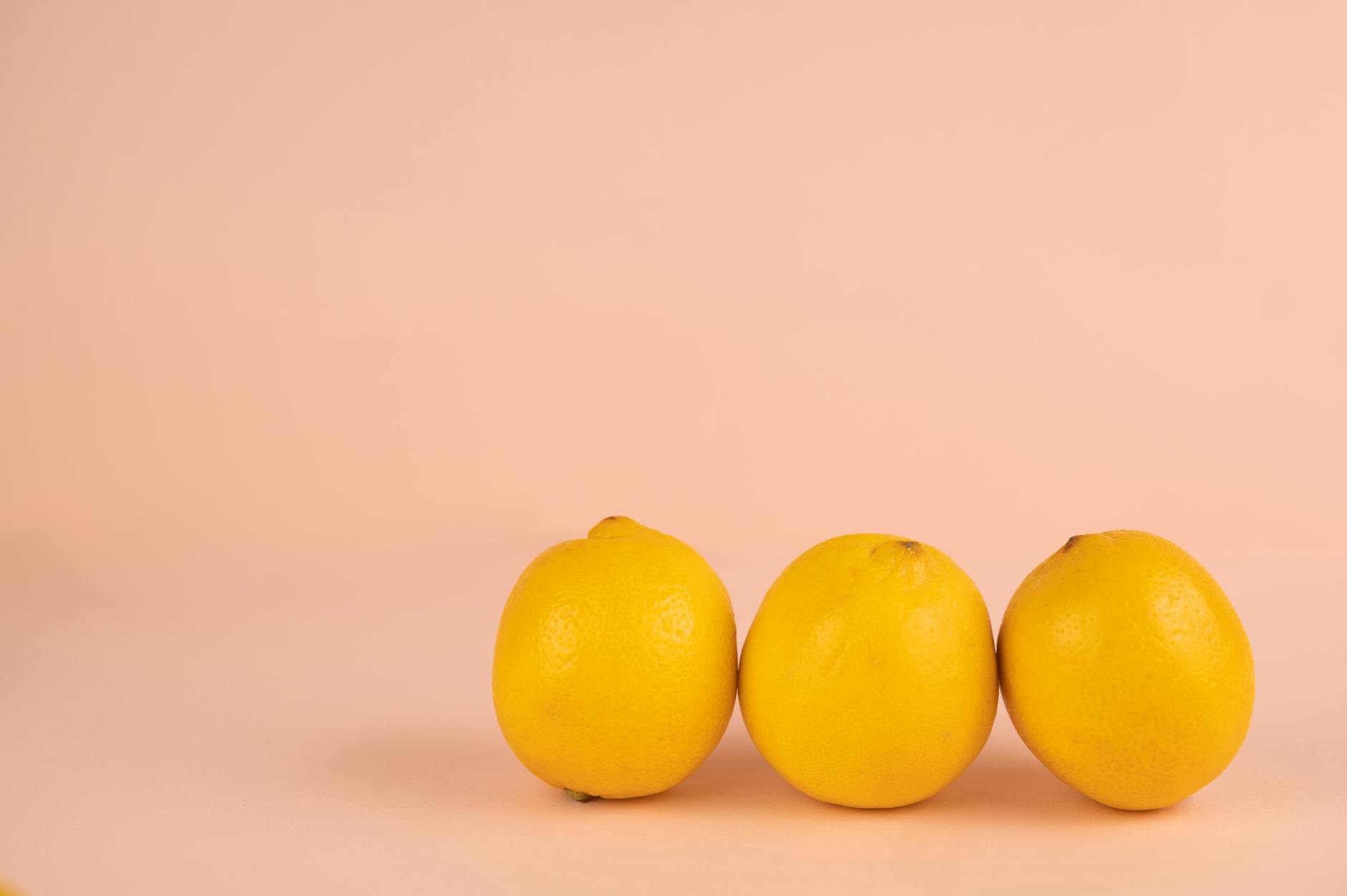 Bright ripe lemons on a pastel background, symbolizing fresh pleasure and renewed sensation